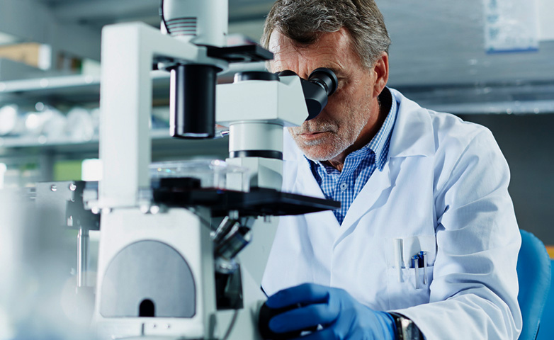 Scientist using a microscope