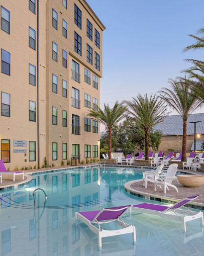 Resort style pool surrounded by lounge chairs