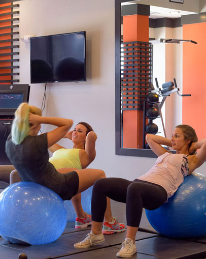 Young women using working out on yoga balls