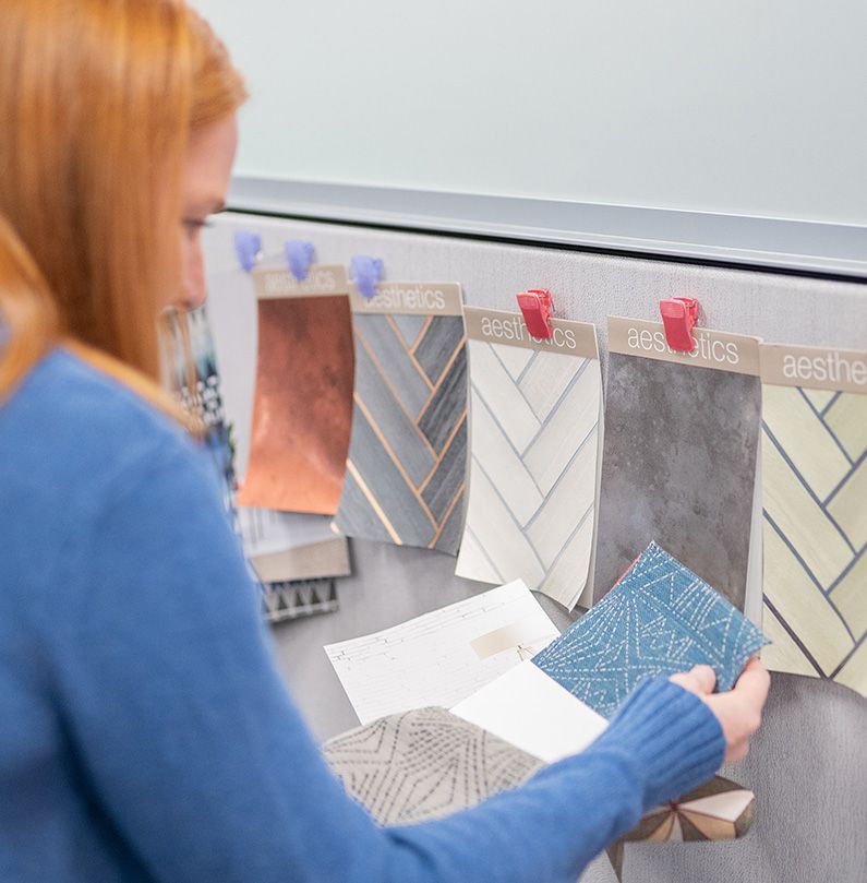 Redheaded young woman looking at swatches