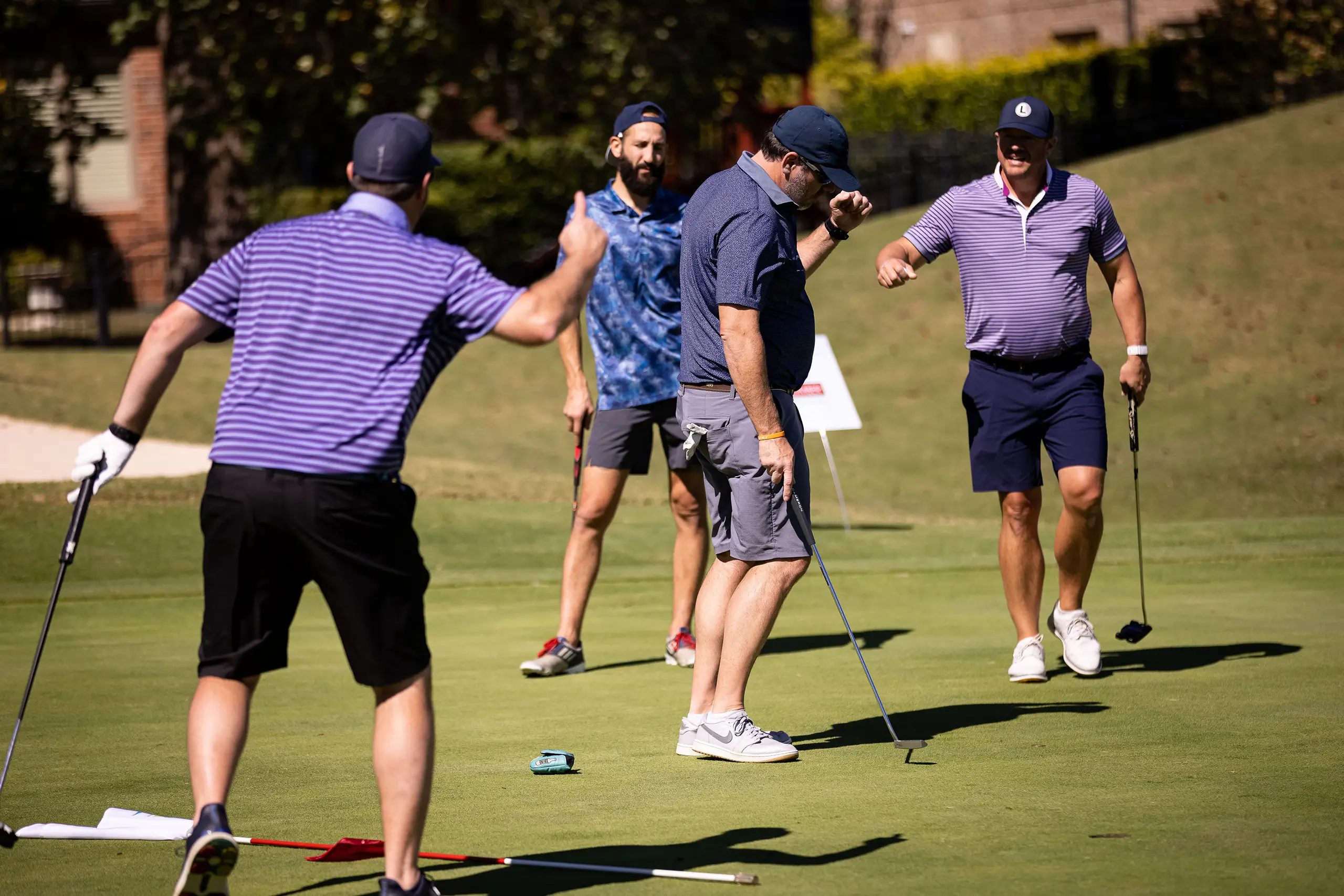 a group of men playing golf