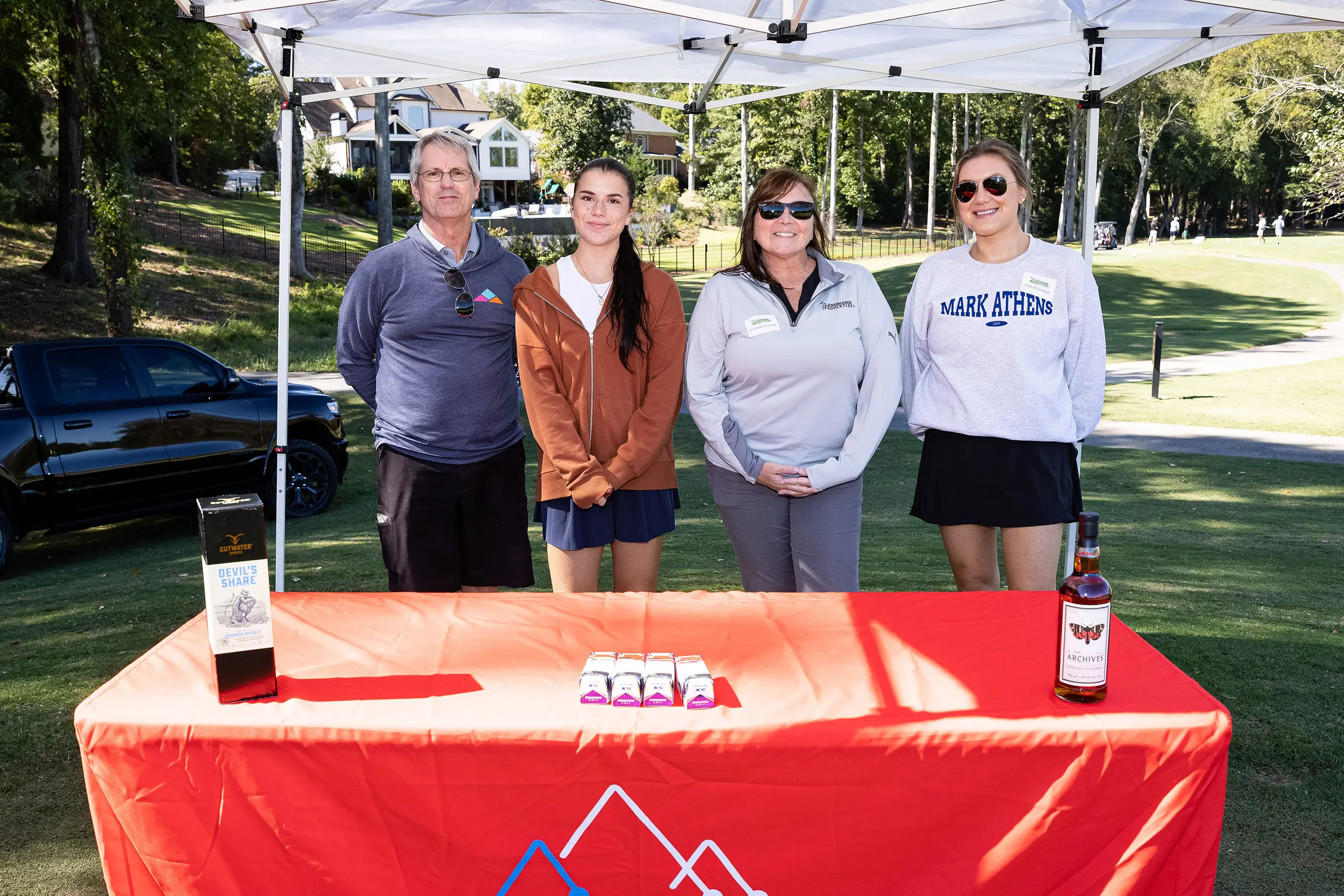 a group of people posing at a booth