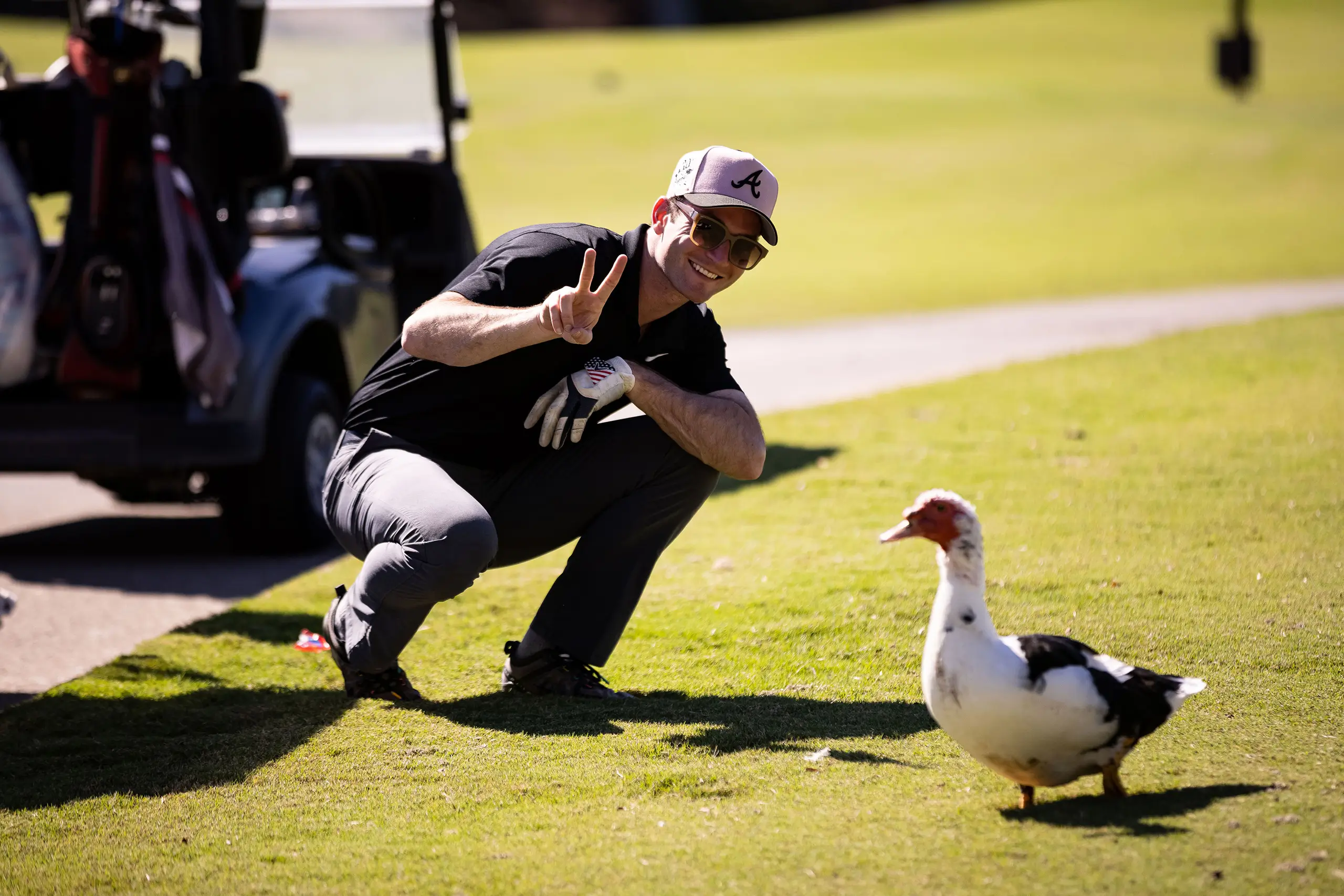 a man posing next to a duck