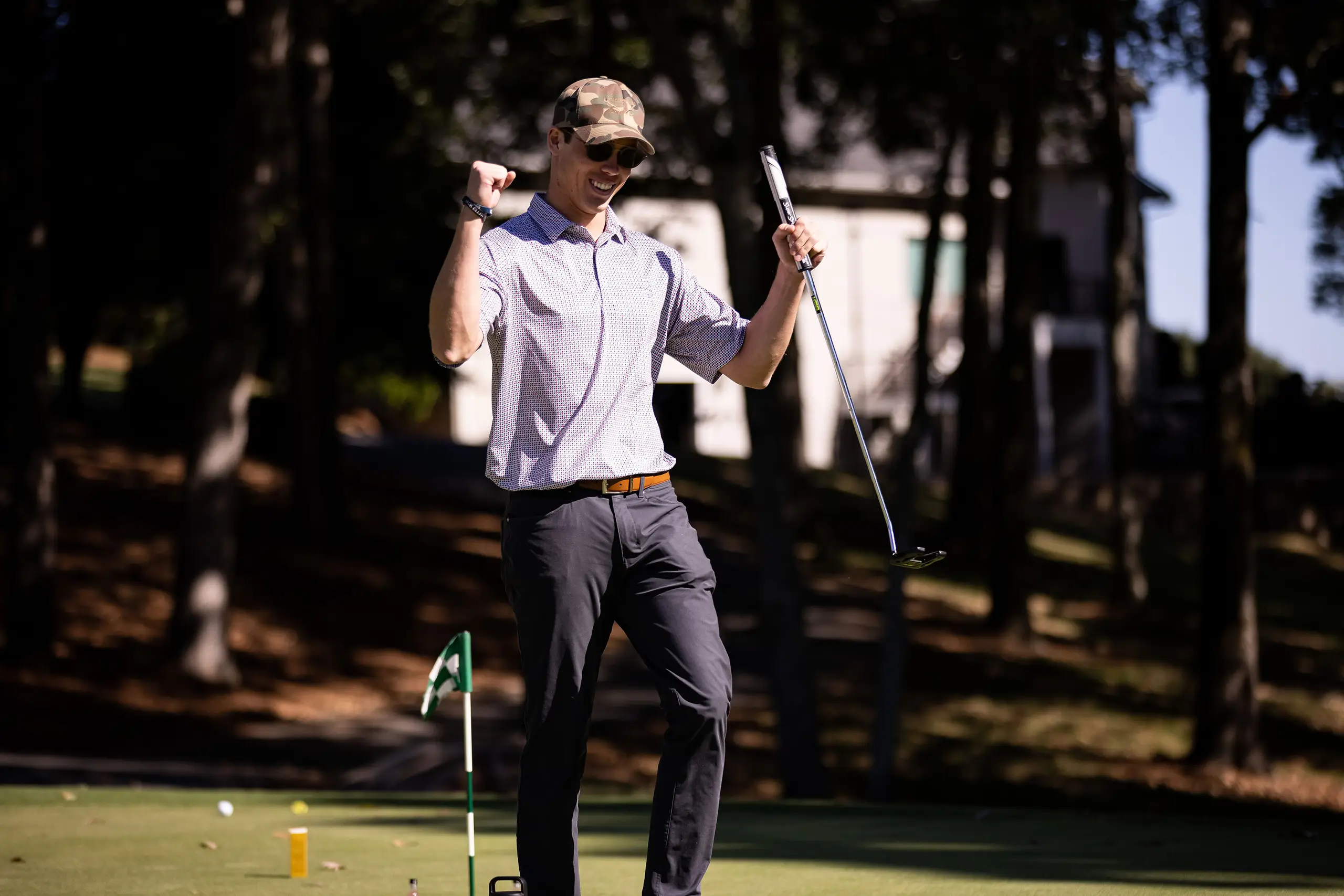 a man celebrating while playing golf