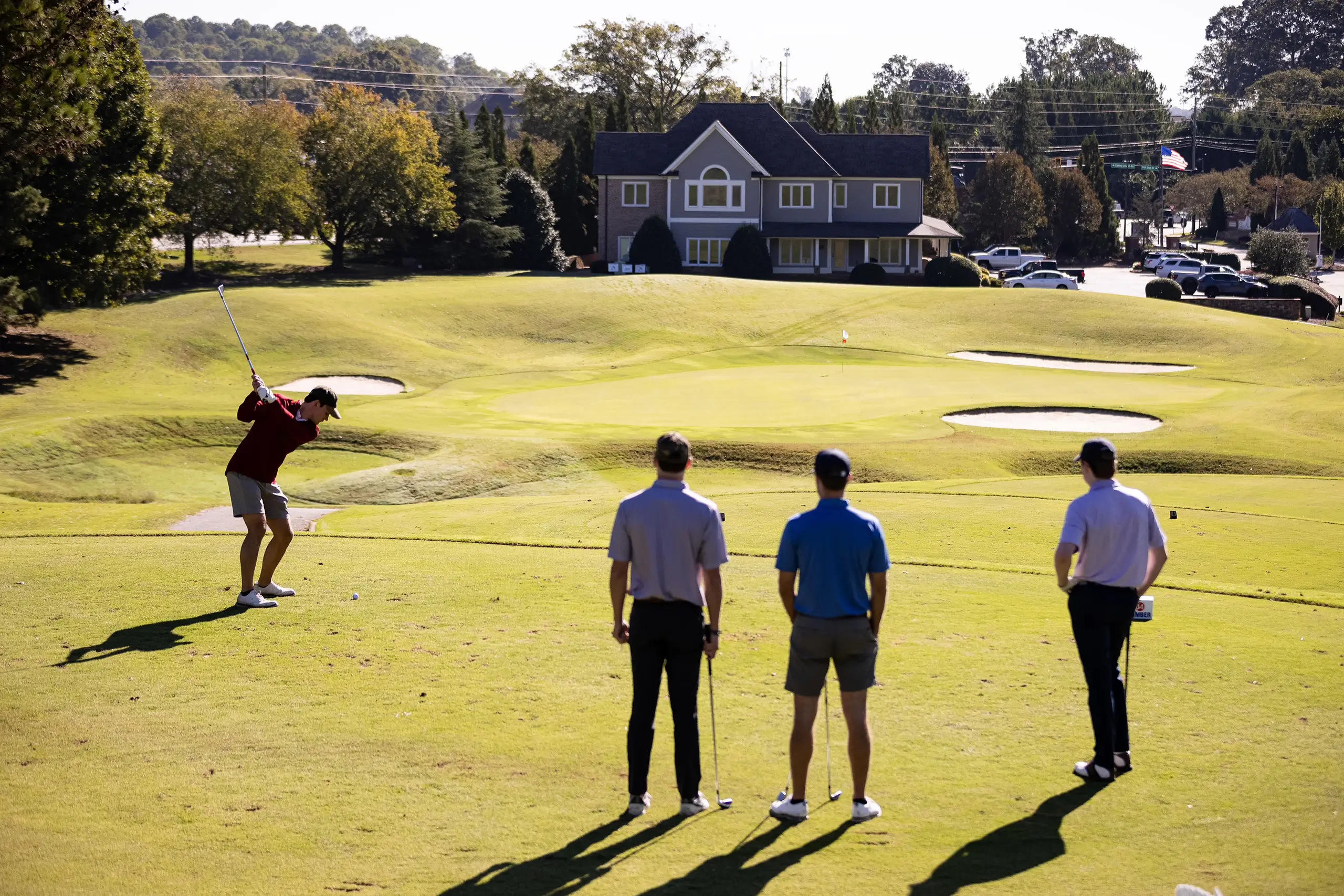 a group of men playing golf